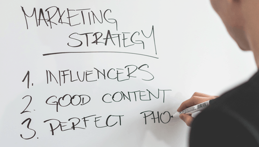marketing-expert-writing-new-marketing-strategy-on-whiteboard-picjumbo-com530