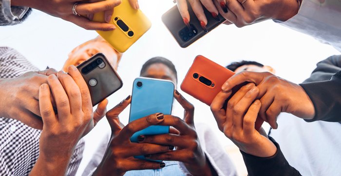 iStock-1371958166-teens-in-a-circle-holding-cellphones